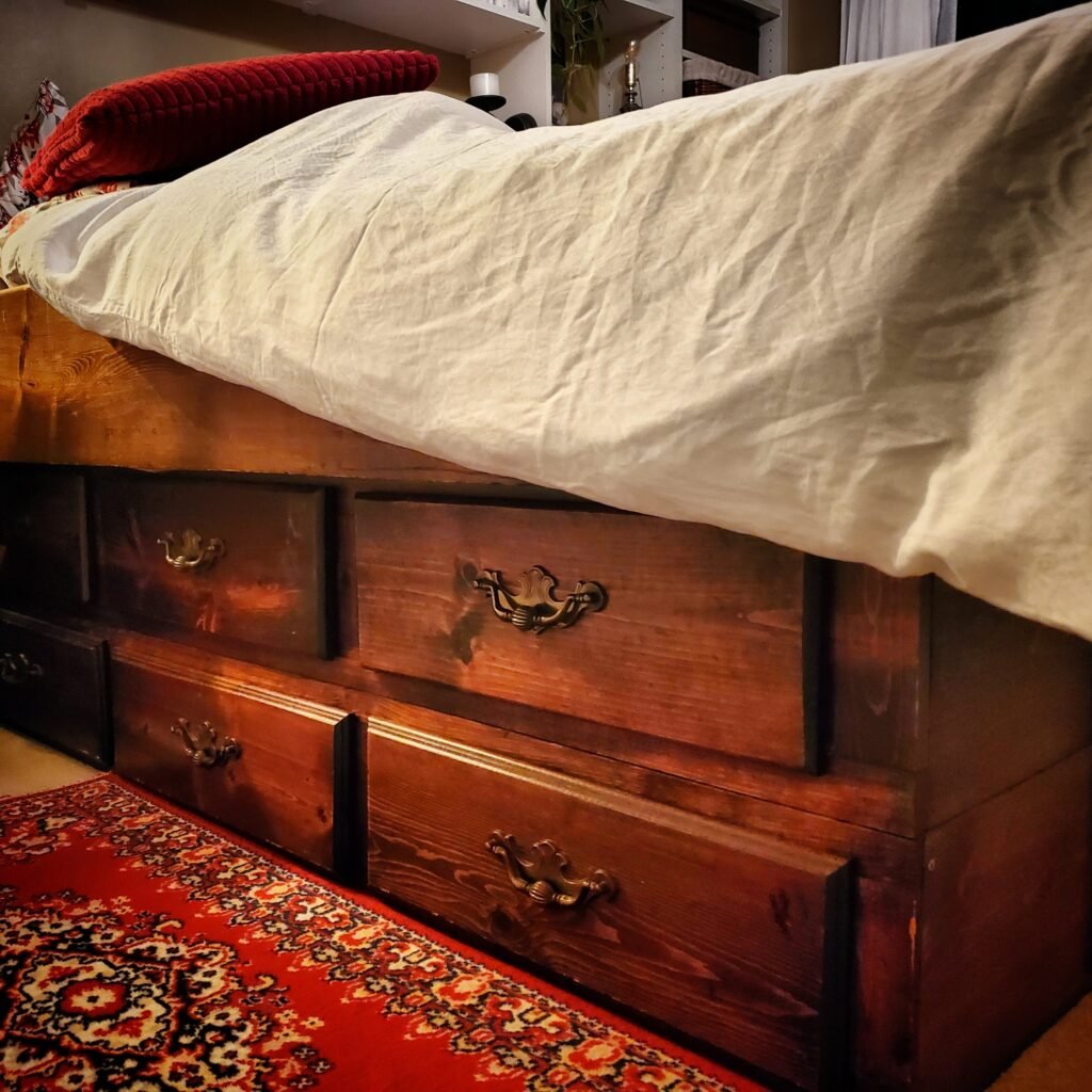 An old waterbed frame. The base boasts 12 drawers! A double mattress fits perfectly.